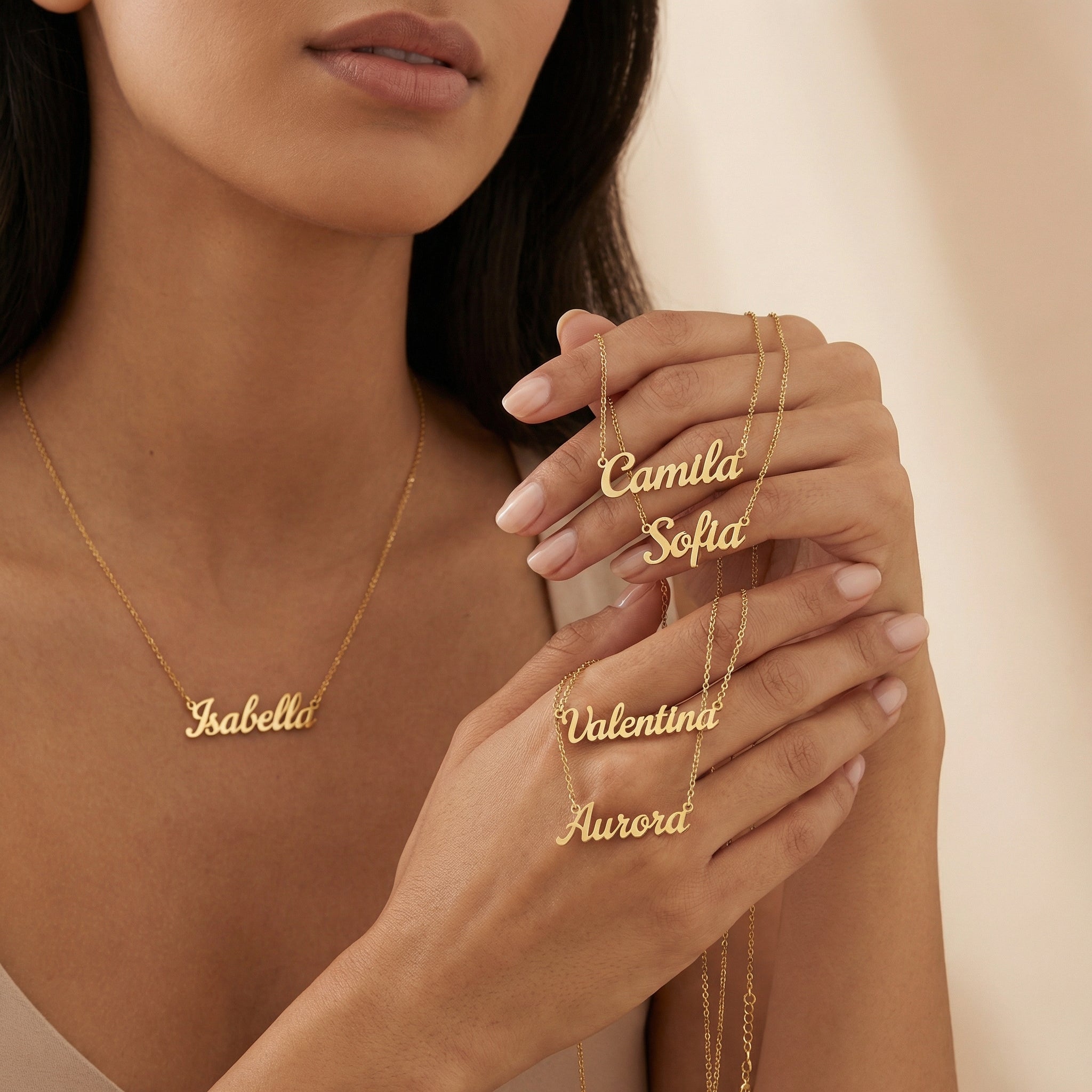 Woman wearing gold name necklaces with a neutral background