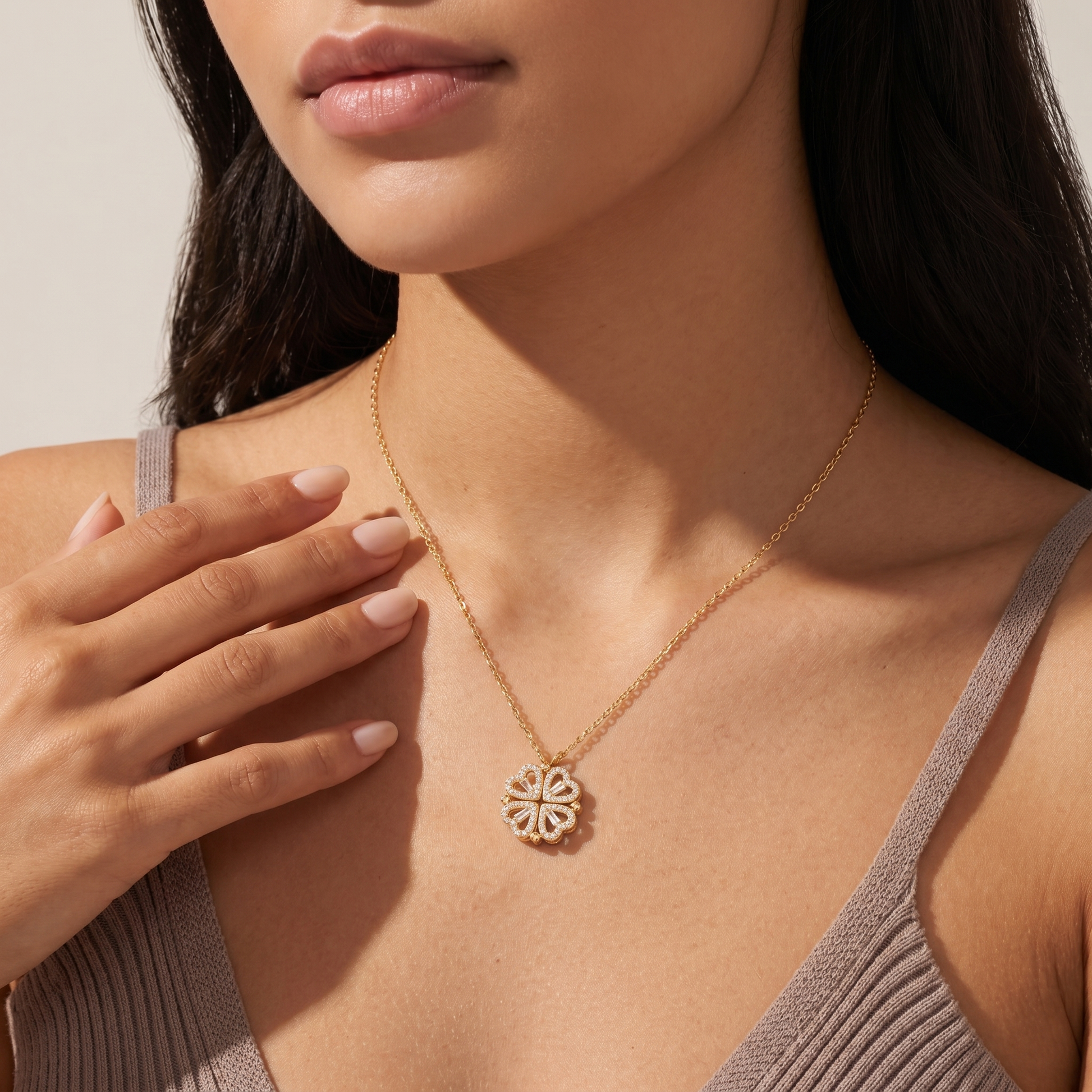 Woman wearing the gold Lucky Heart clover necklace at her collarbone