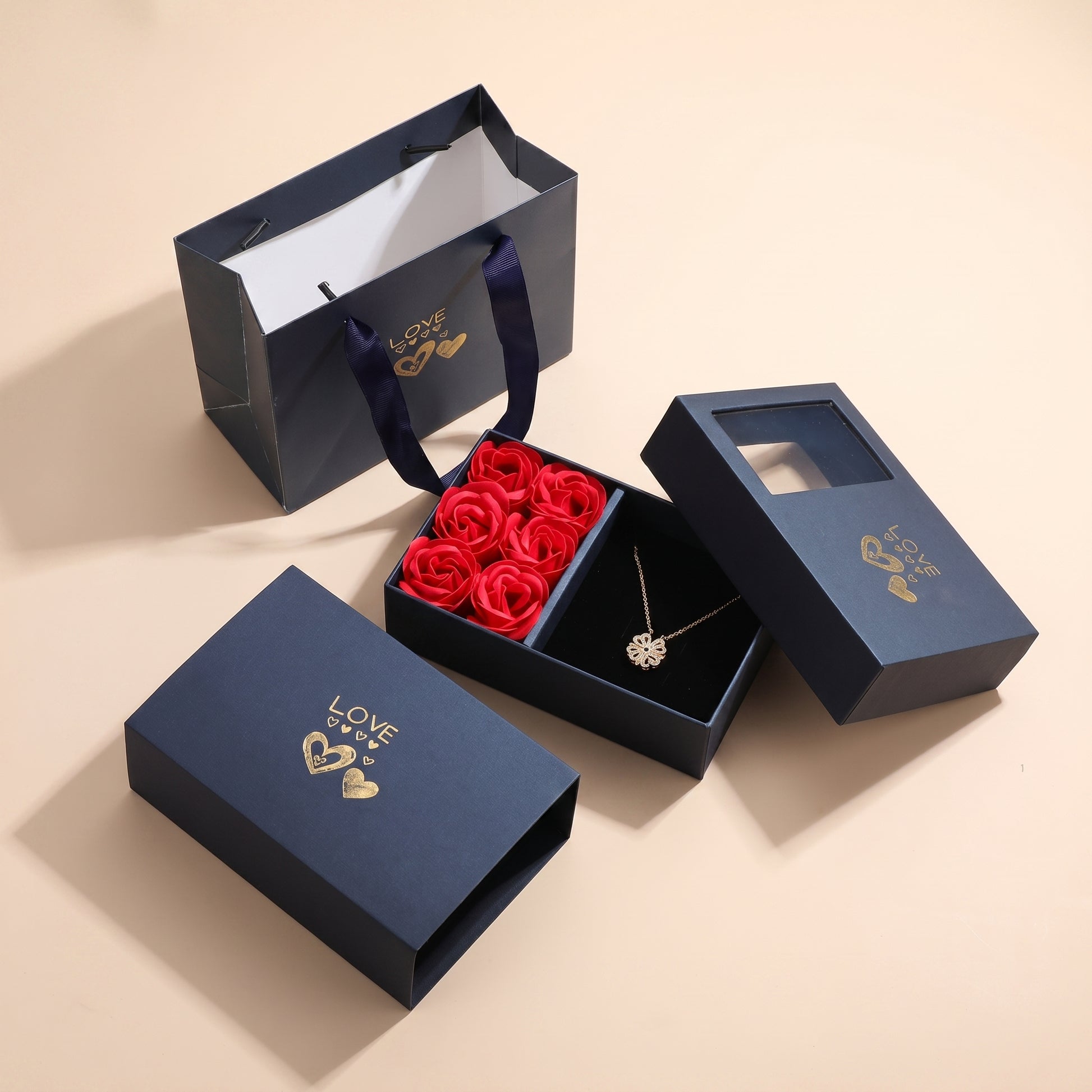 Lucky Heart necklace 6 Roses gift box set — navy LOVE box with red roses, necklace and matching gift bag on beige
