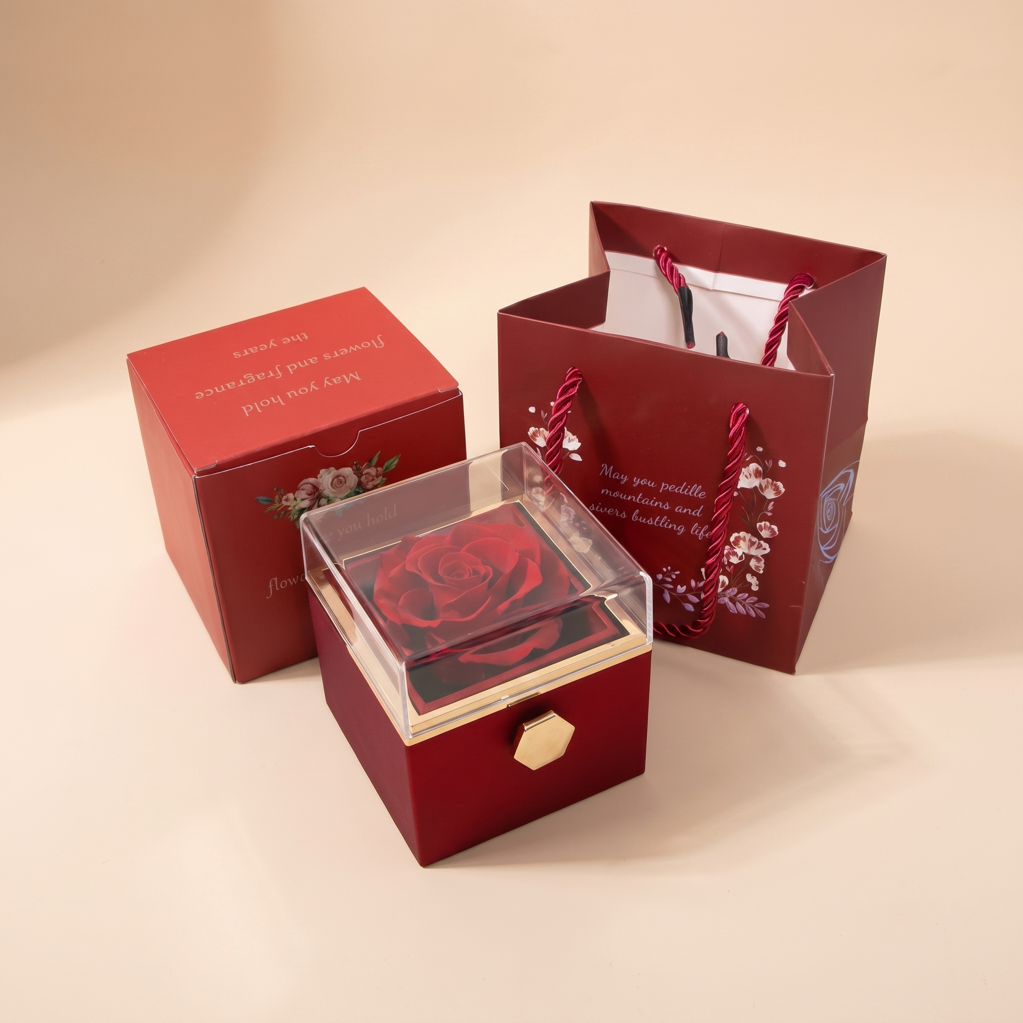 Lucky Heart necklace Eternal Rose gift box — burgundy rotating preserved-rose box with matching gift bag on beige