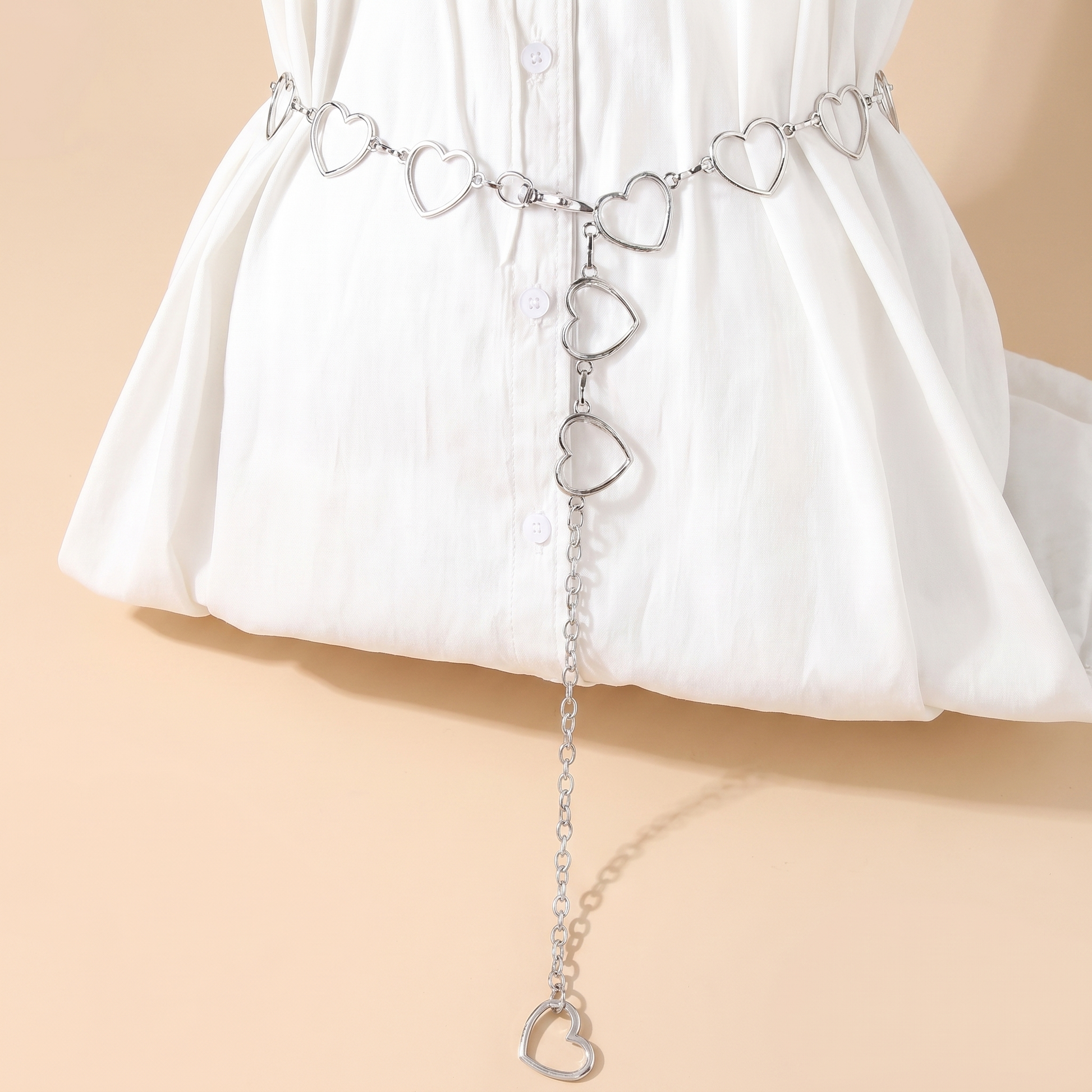 Crystal fringe chain waist belt body chain on a soft beige background