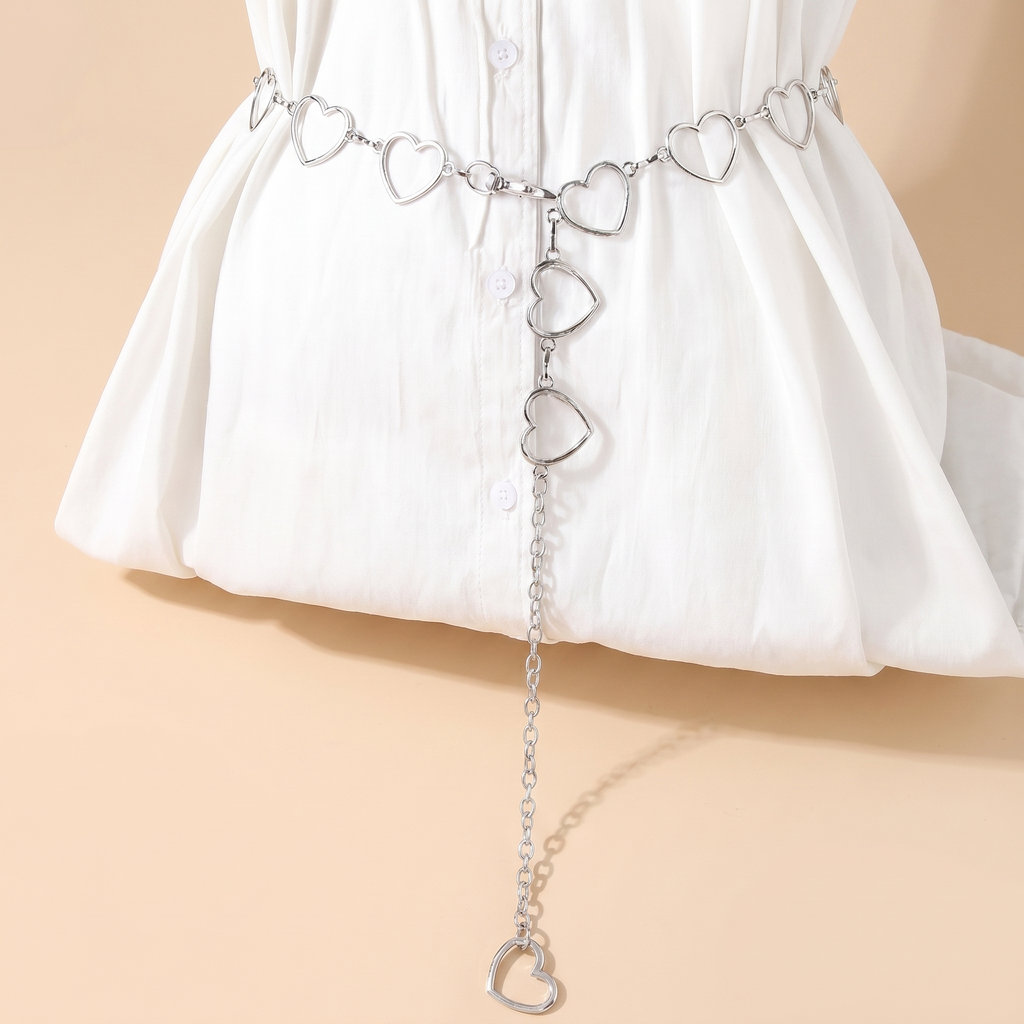 Crystal fringe chain waist belt body chain on a soft beige background