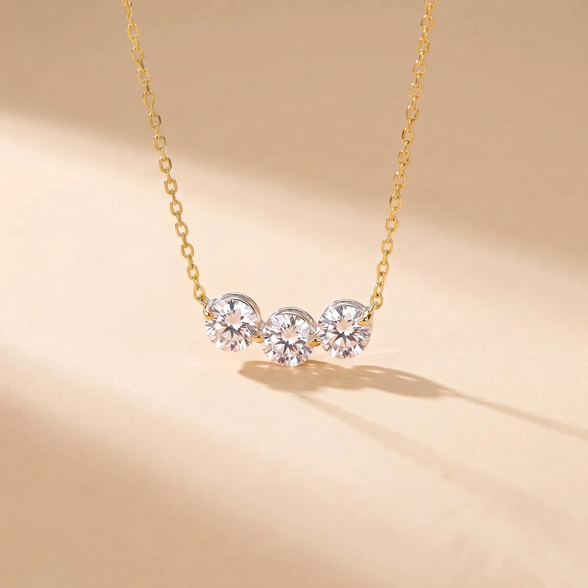 Sterling silver three-stone zircon necklace on a soft beige background