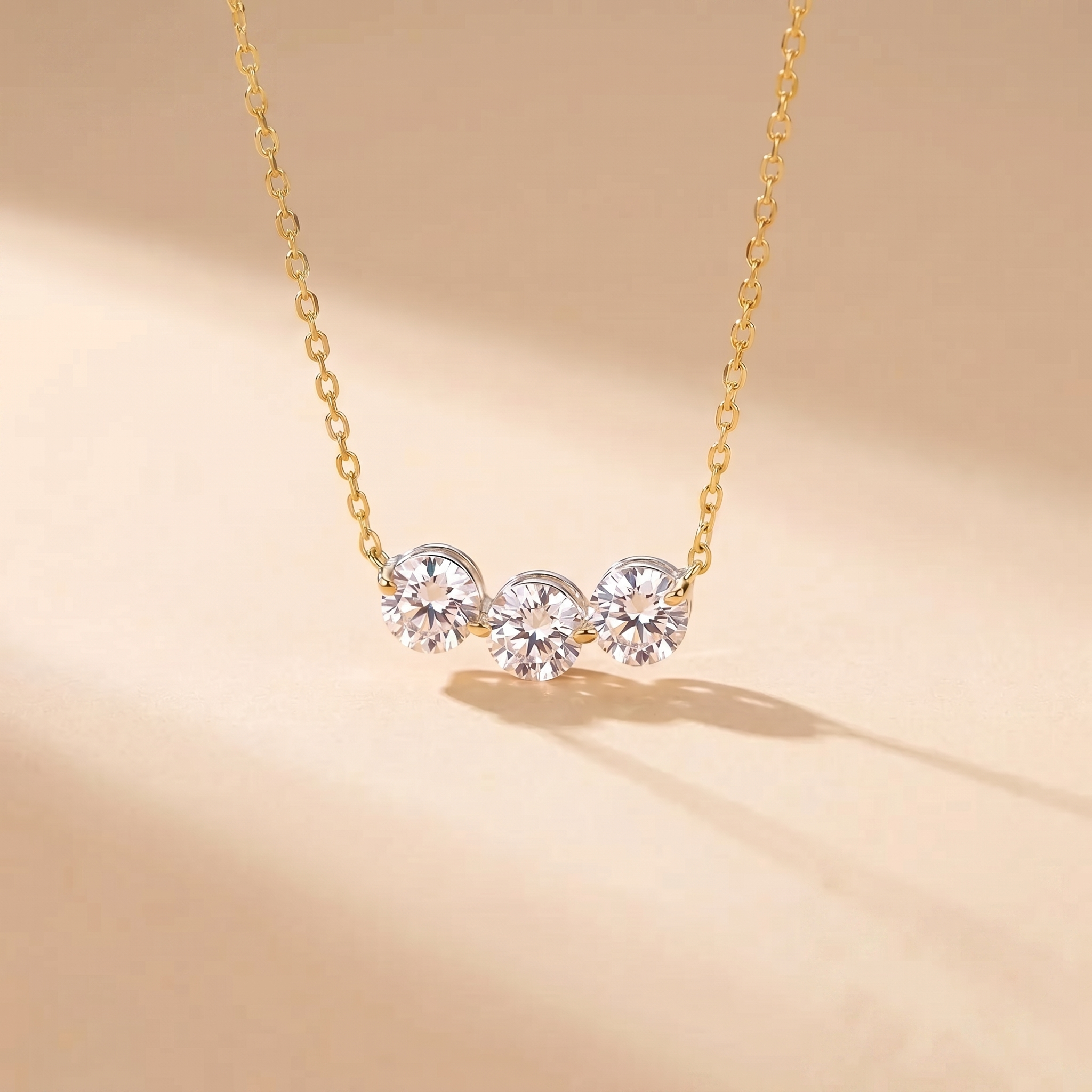 Sterling silver three-stone zircon necklace on a soft beige background