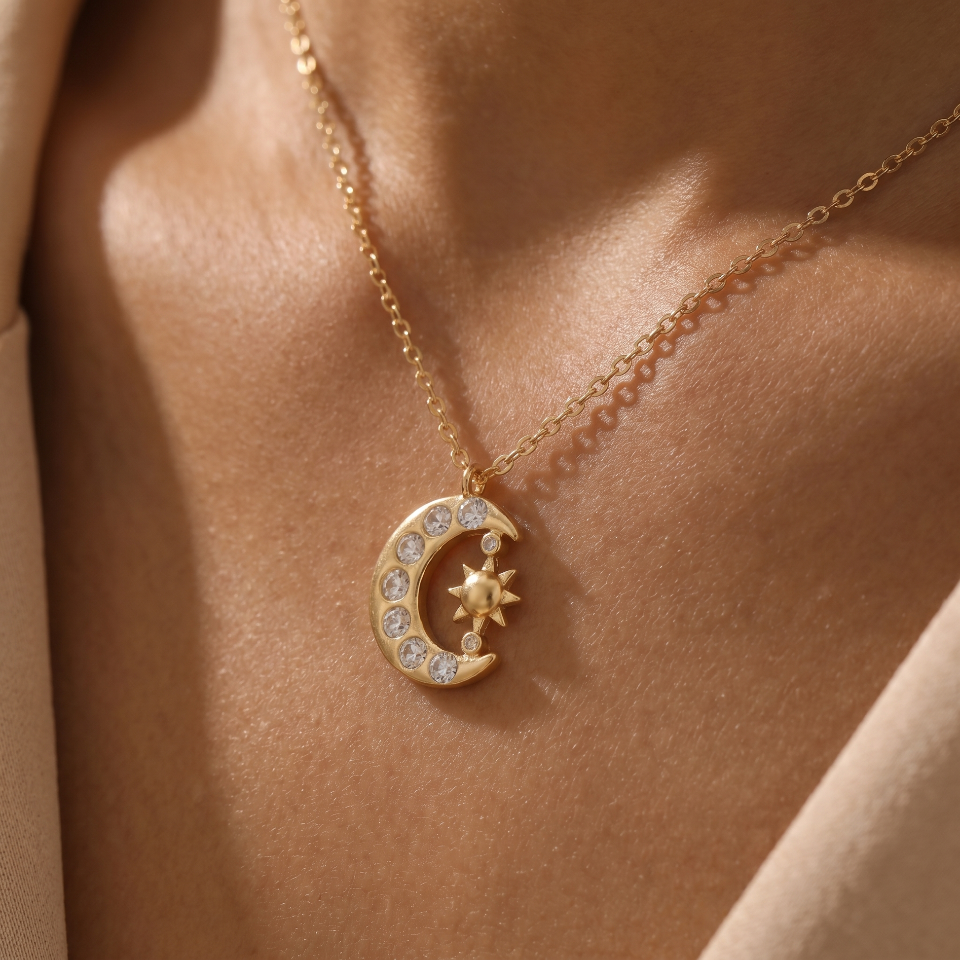 Close-up of the sun and crescent moon pendant on skin