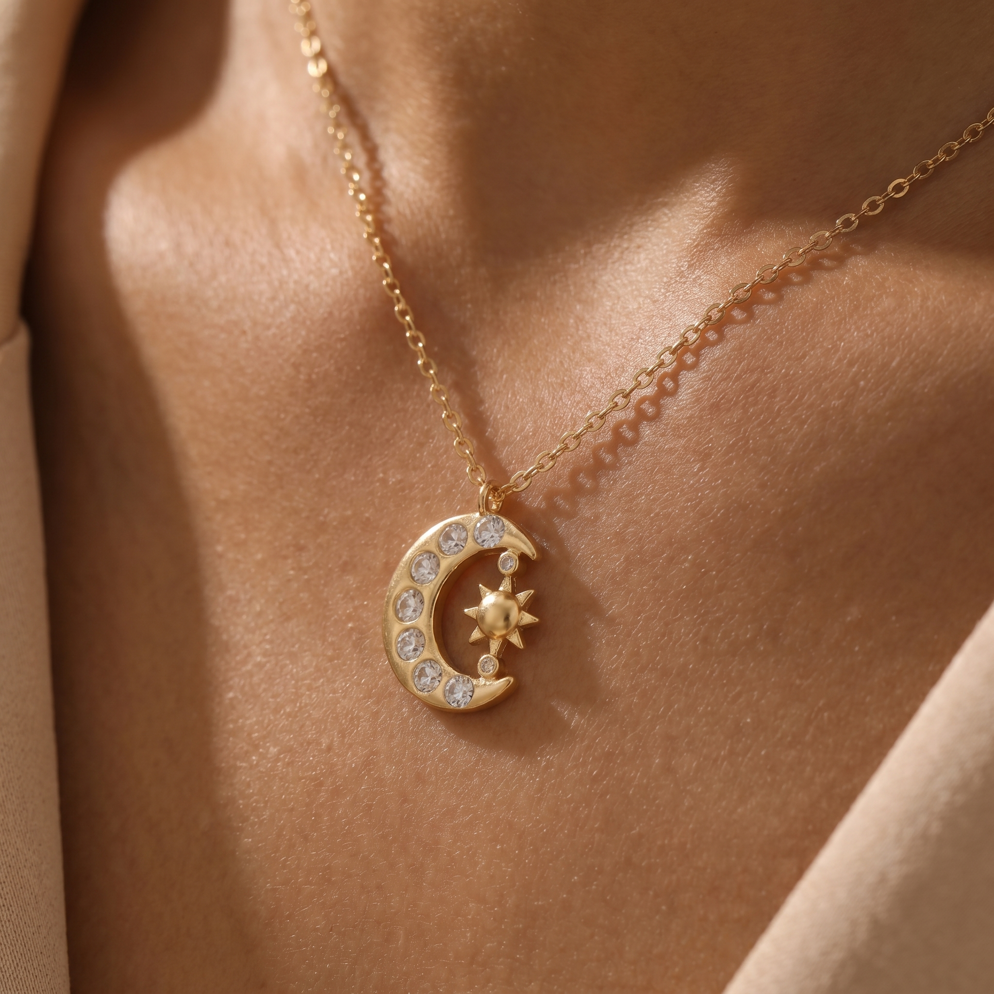 Close-up of the sun and crescent moon pendant on skin