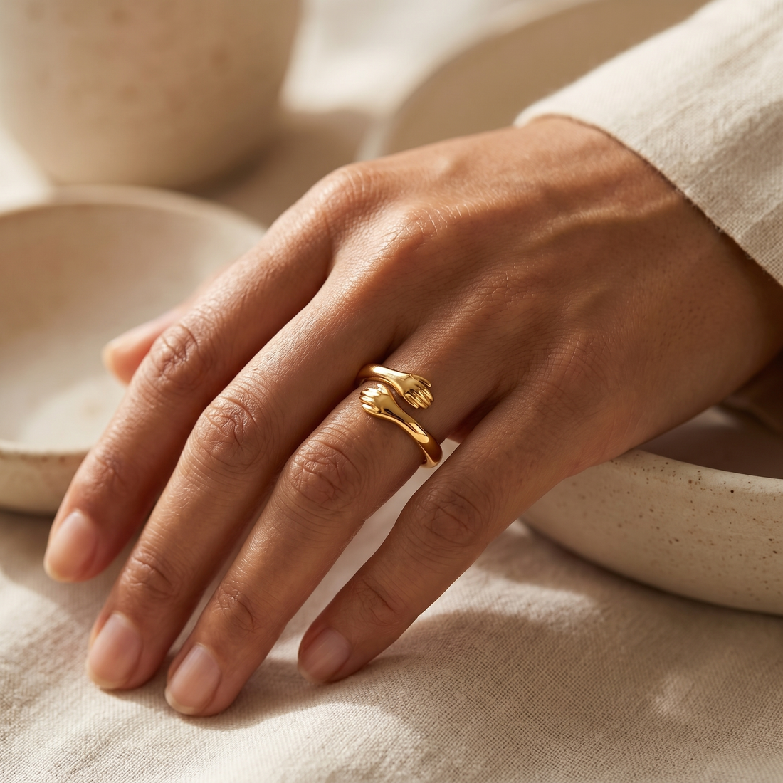 Gold hug ring on a soft beige background with Sale 1+1 badge