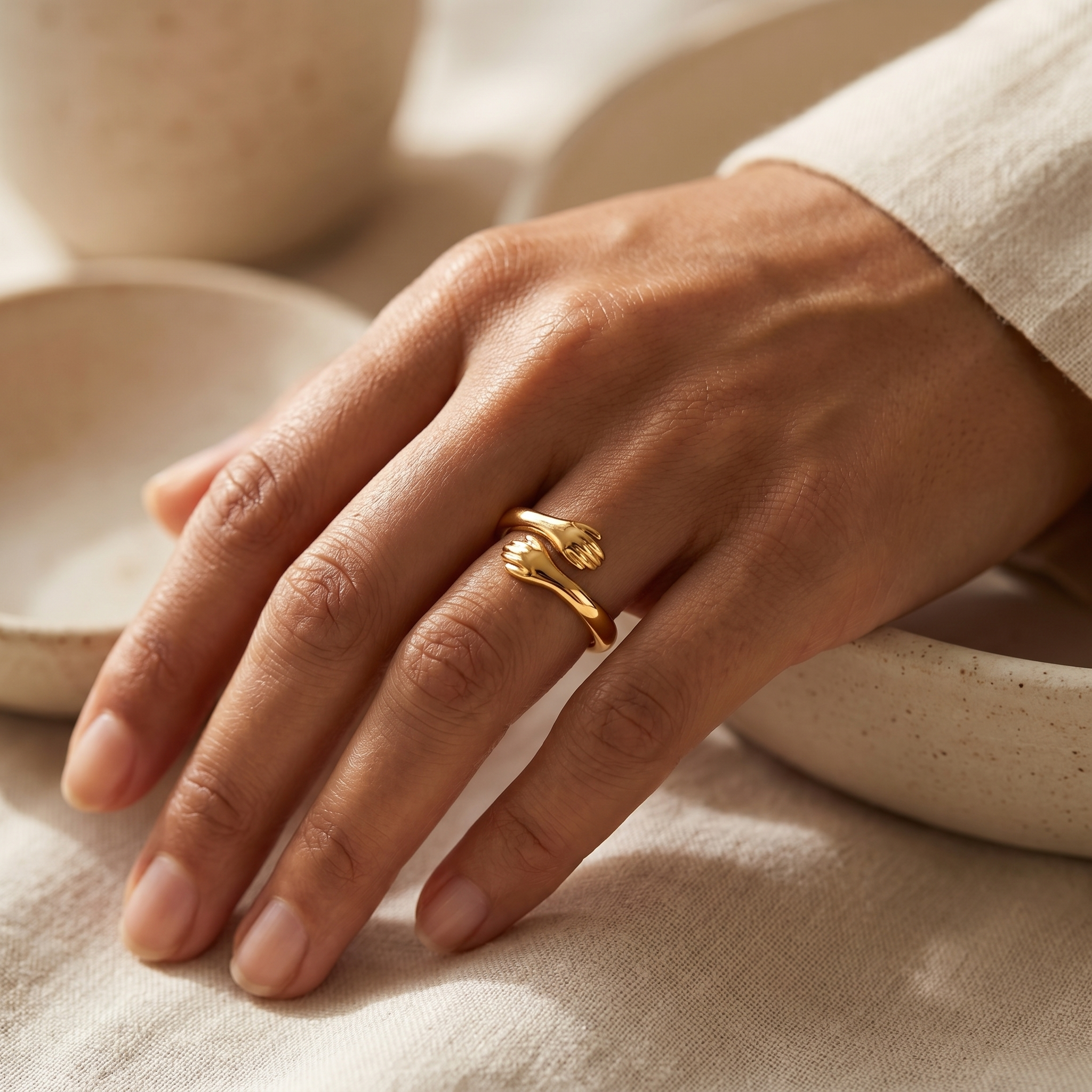 Gold hug ring worn on hand, warm beige lifestyle