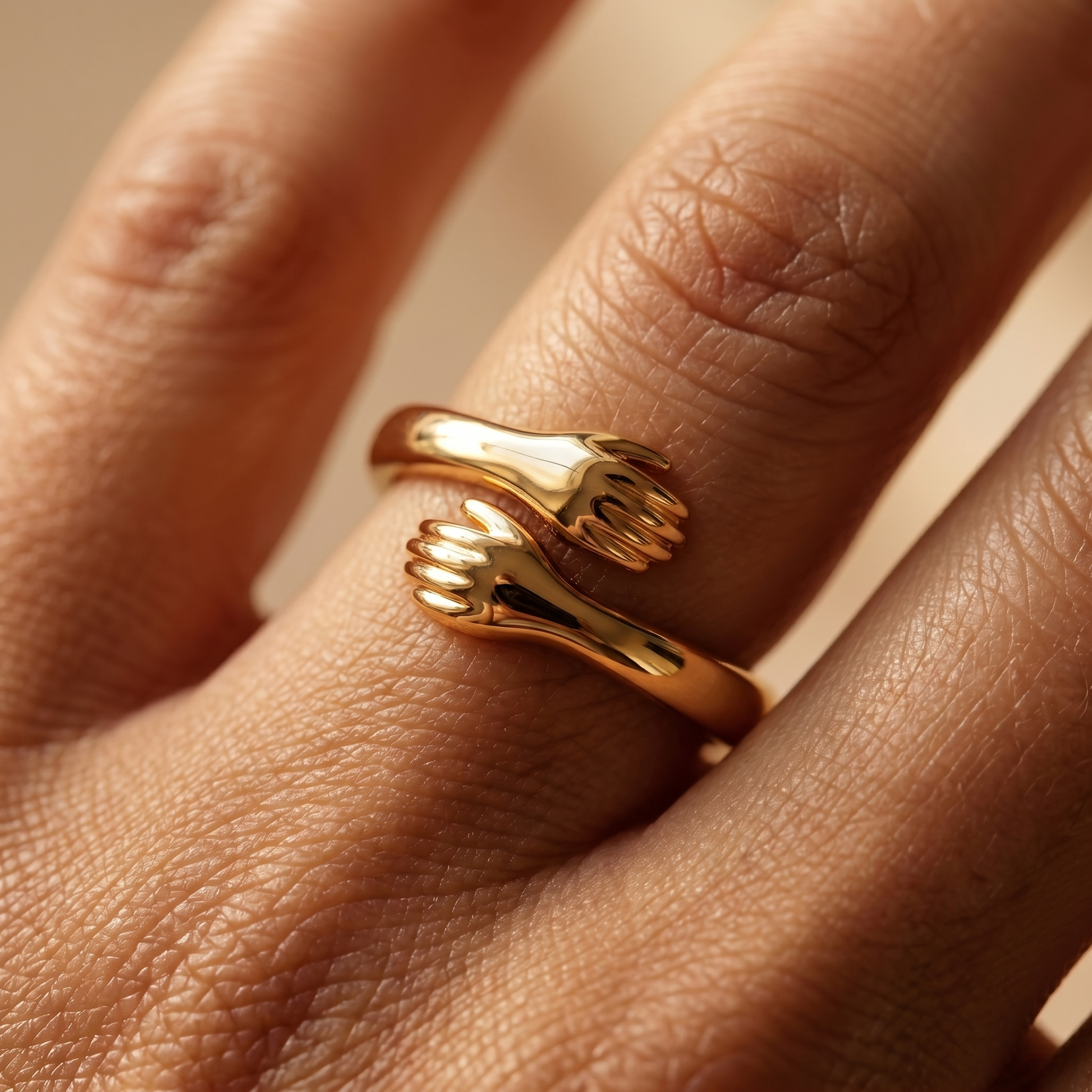 Close-up of the gold hug ring on finger