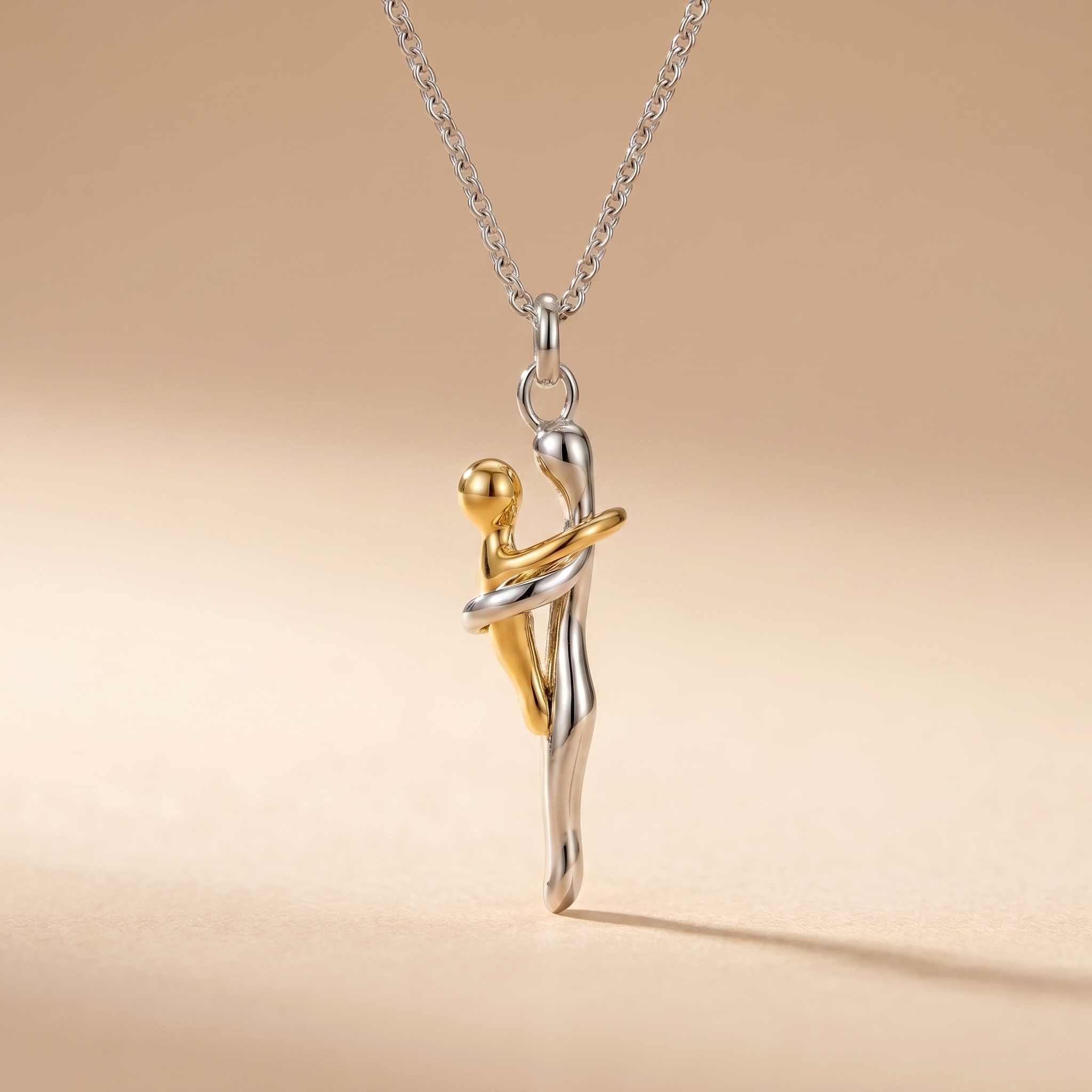 Macro detail of the mother and child pendant on beige