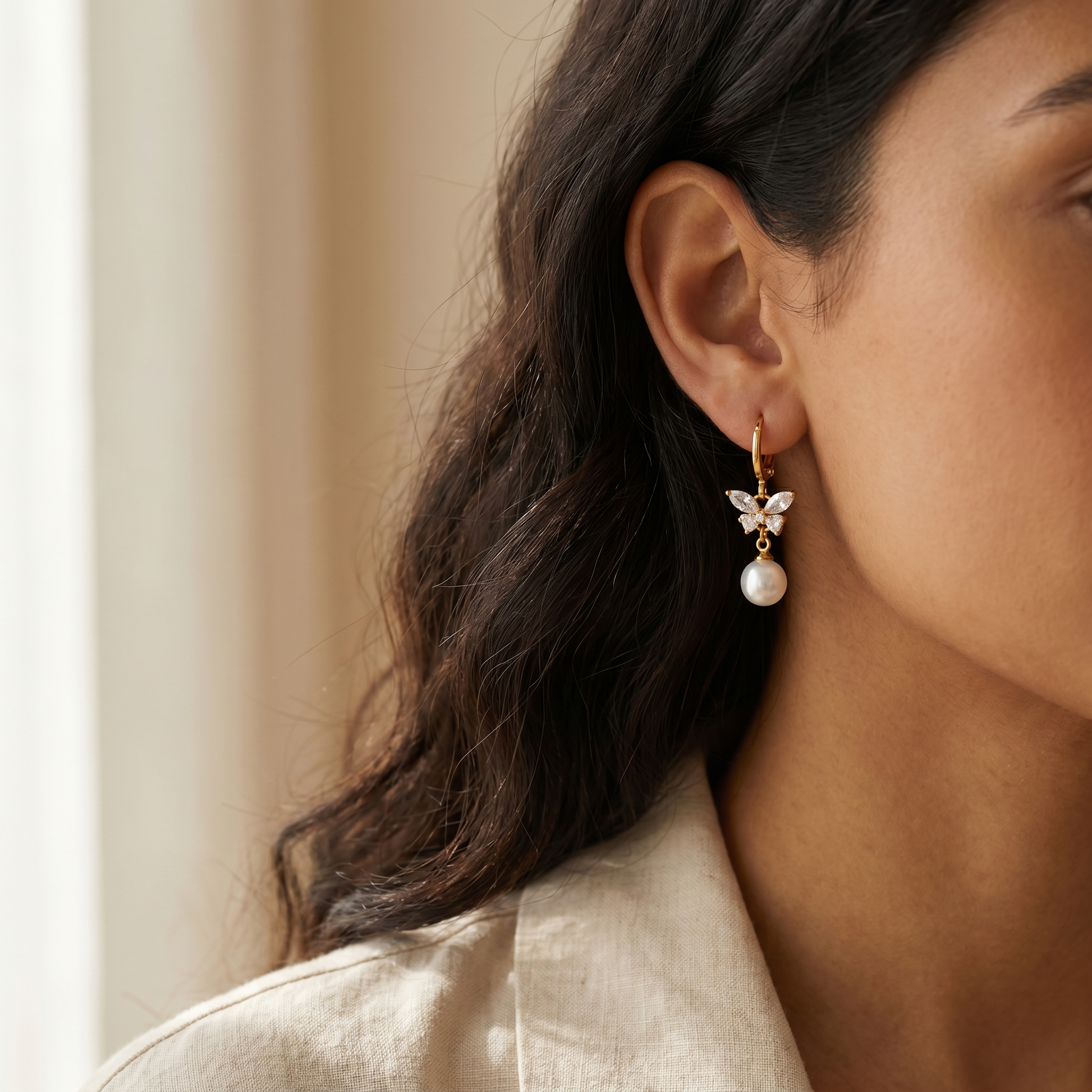 Butterfly Pearl Drop Earrings worn on ear