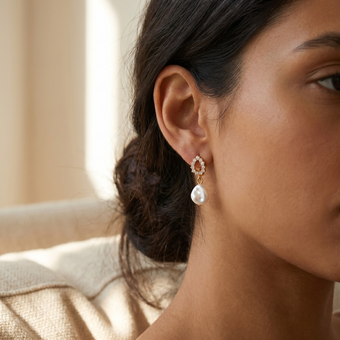 Pave Pearl Drop Huggie Earrings on soft beige background