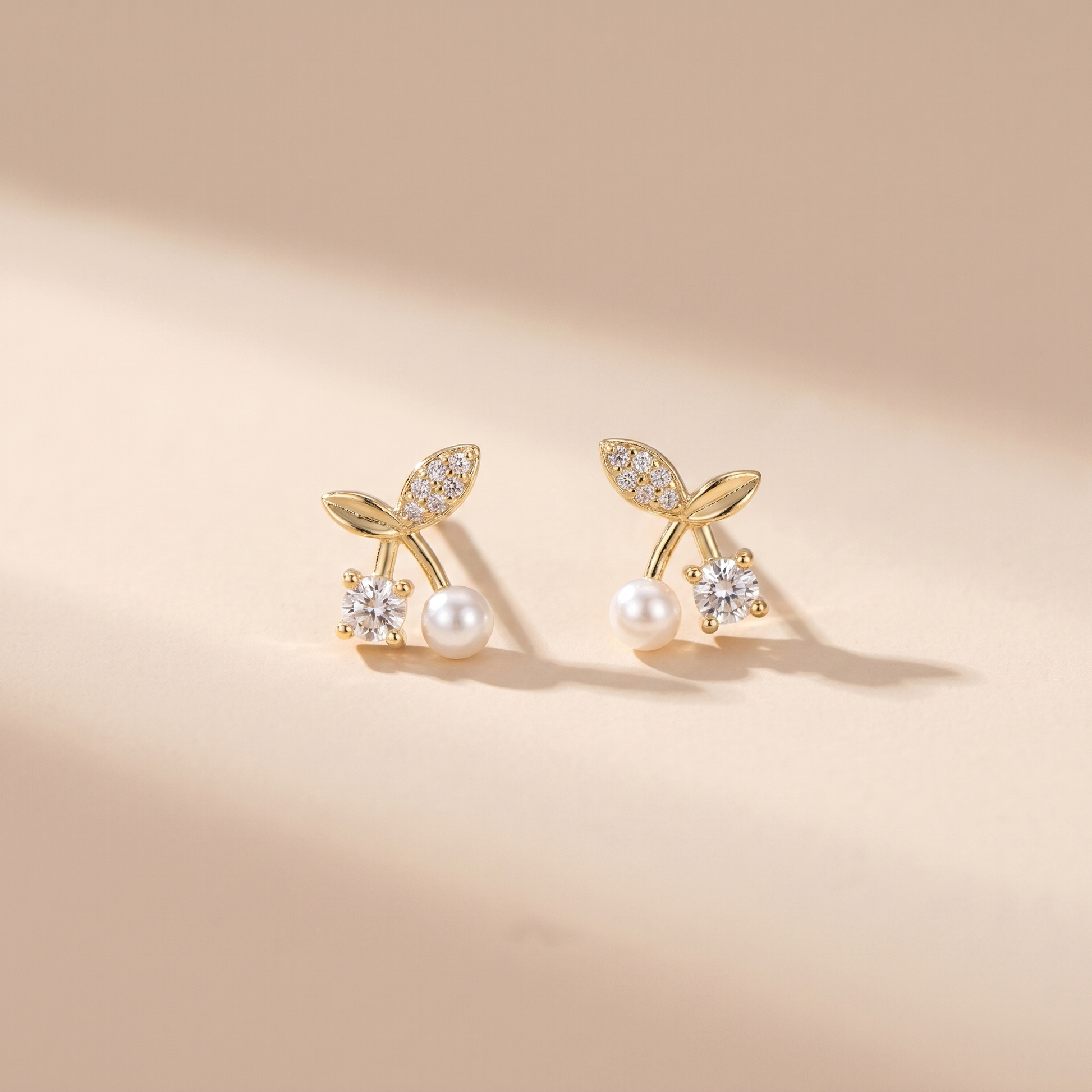 Petite Pearl Sprig Stud Earrings on soft beige background