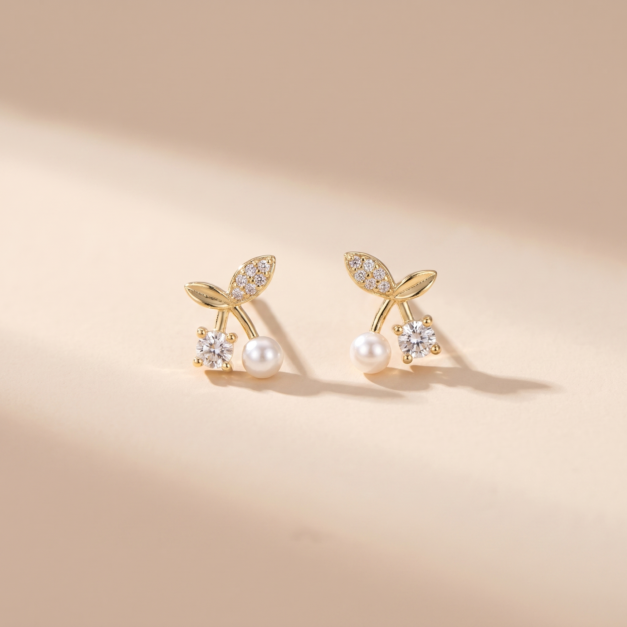 Petite Pearl Sprig Stud Earrings on soft beige background