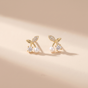 Petite Pearl Sprig Stud Earrings on soft beige background