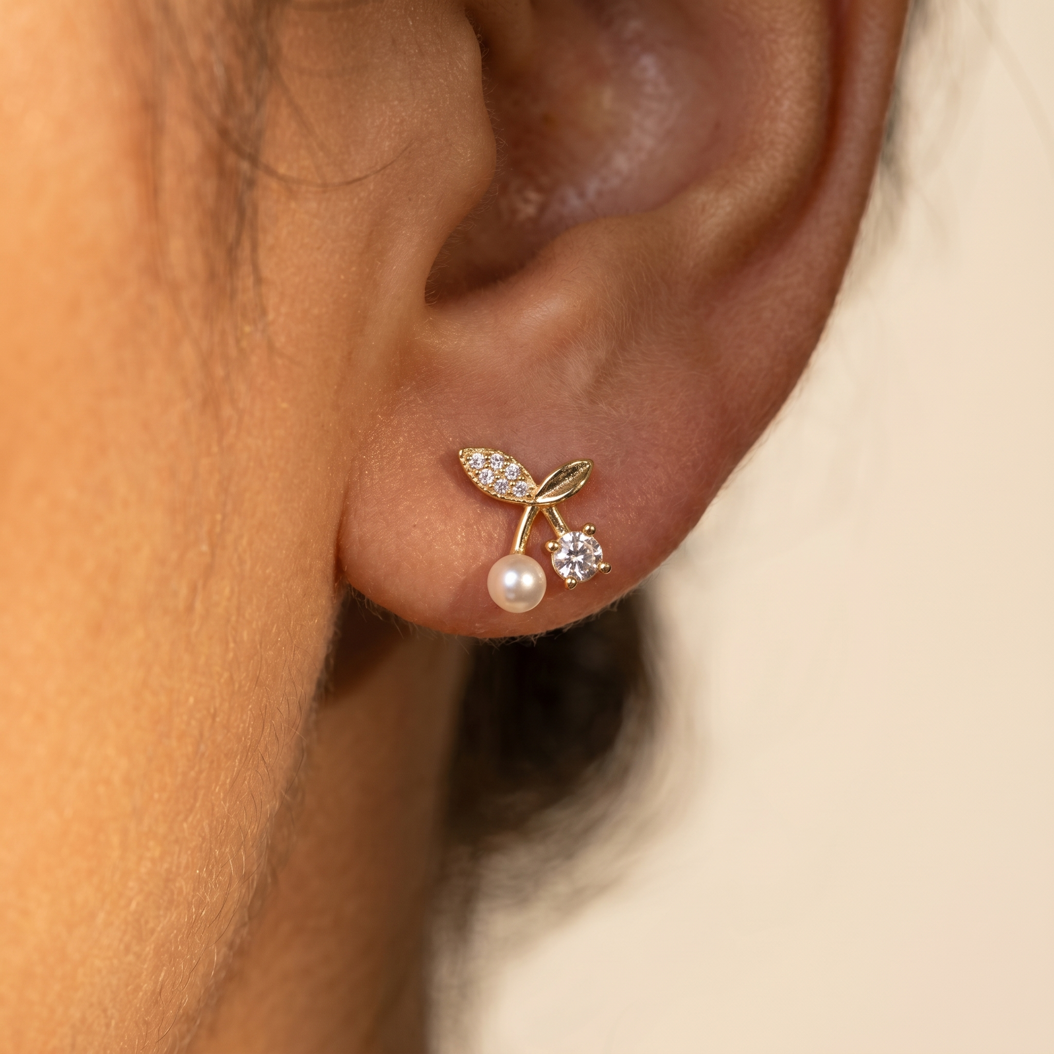 Petite Pearl Sprig Stud Earrings close-up on ear