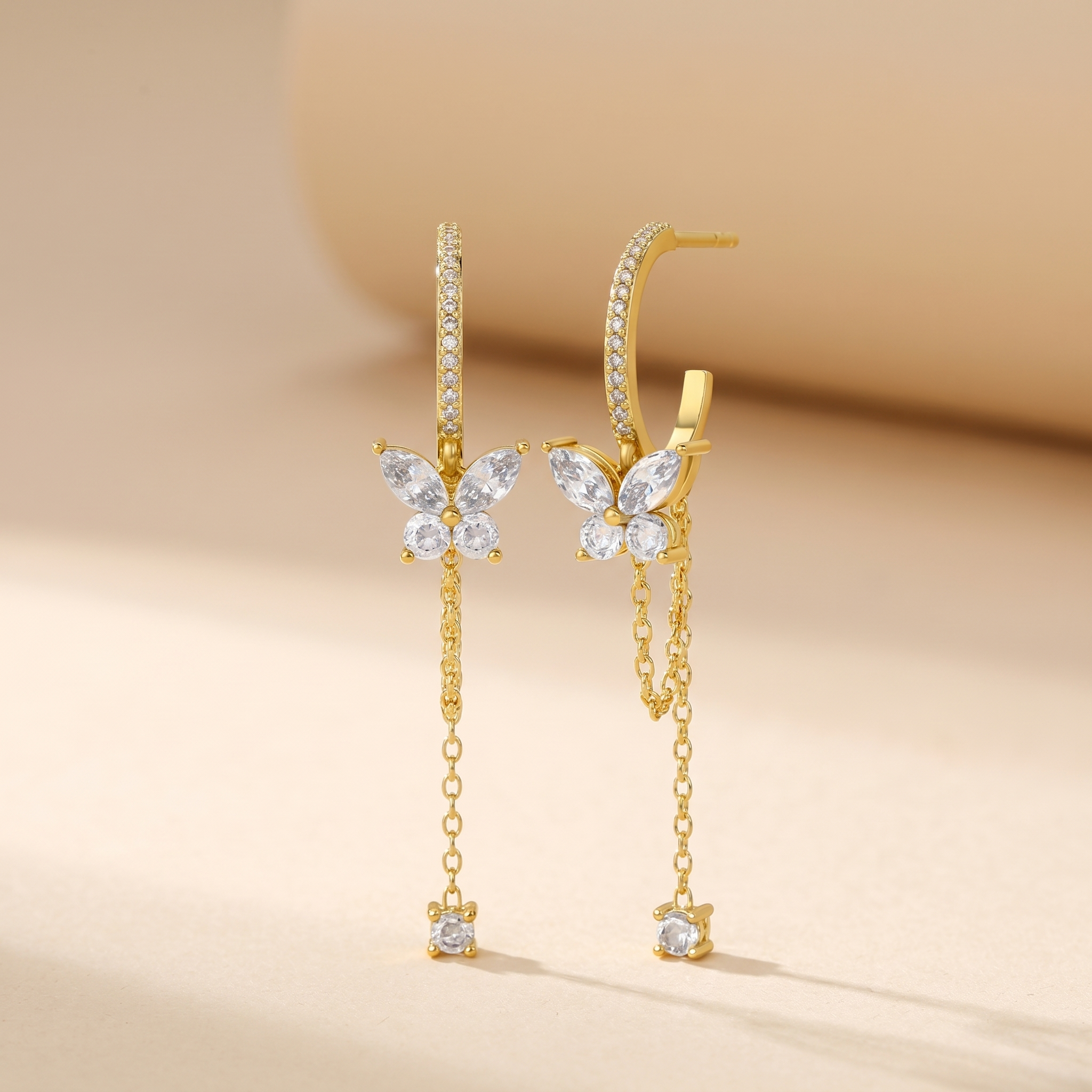 Butterfly Chain Drop Stud Earrings on soft beige background