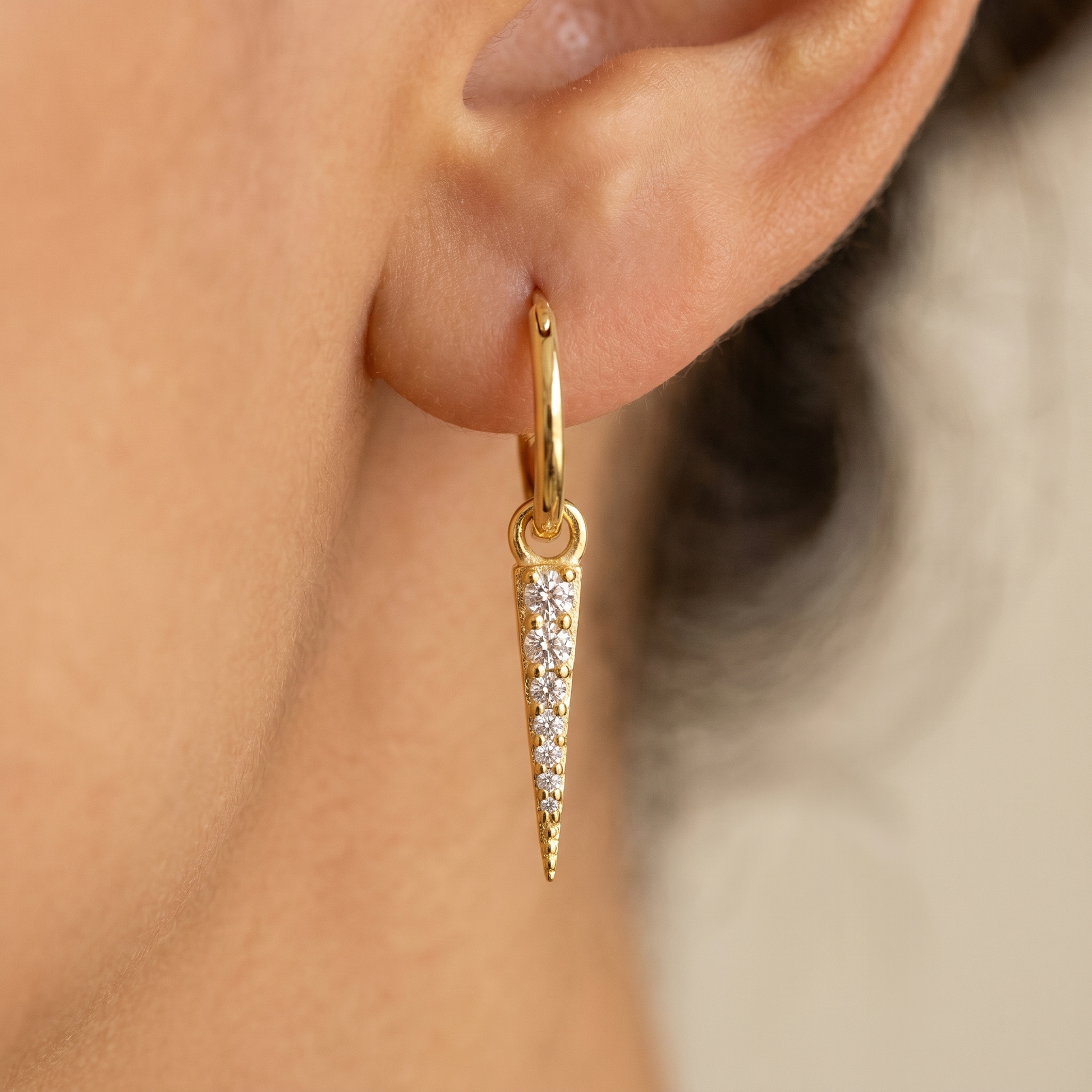 Pave Spike Dagger Huggie Earrings close-up on ear