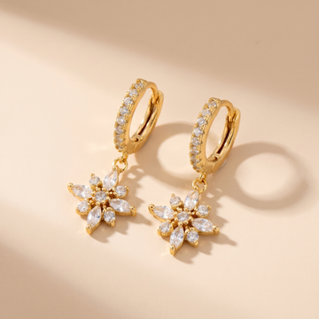 Crystal Flower Huggie Drop Earrings on soft beige background