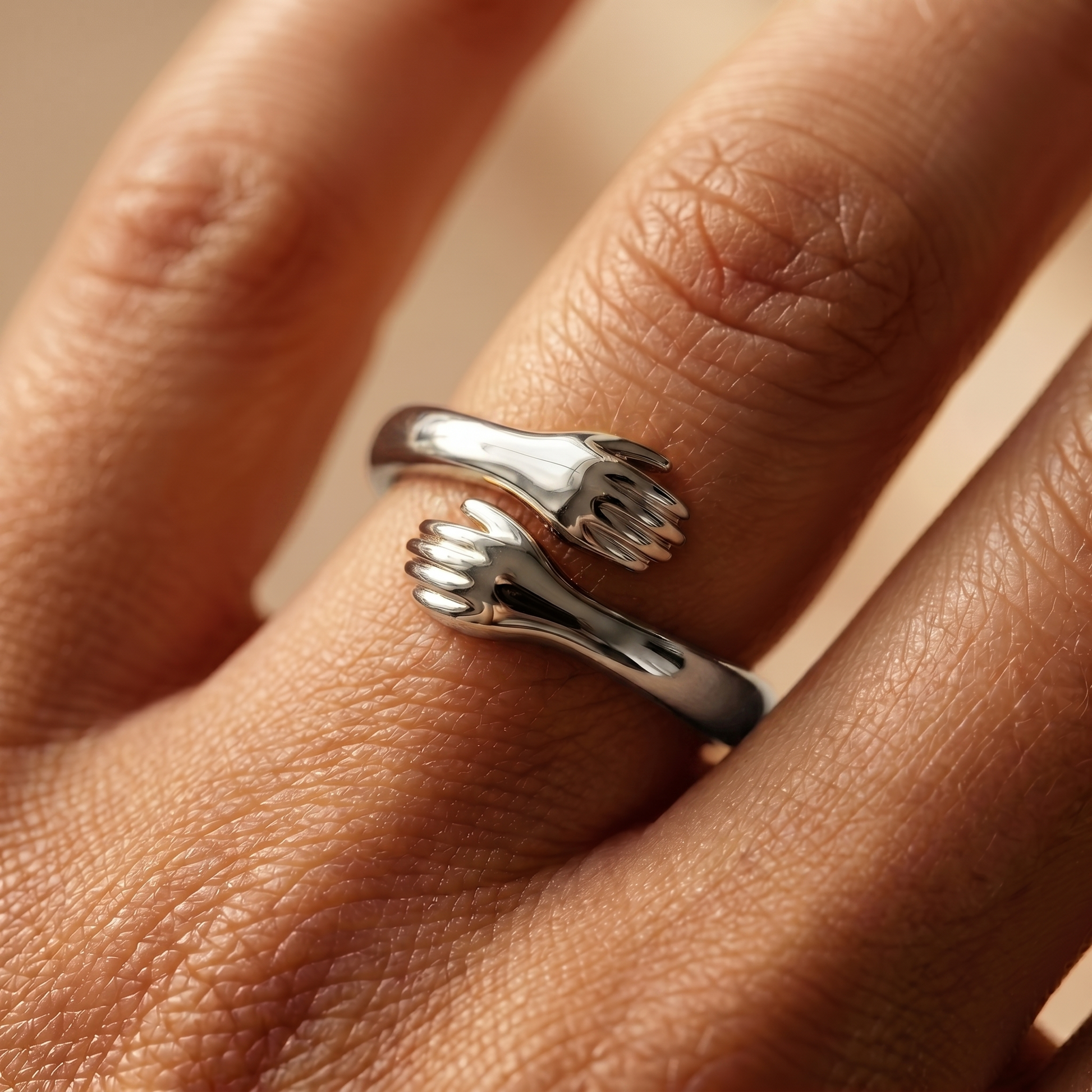 Close-up of the silver hug ring on finger