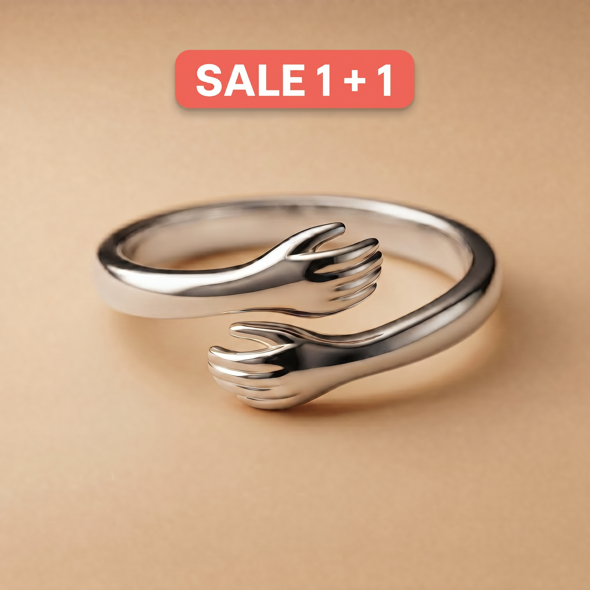 Silver hug ring on a soft beige background with Sale 1+1 badge